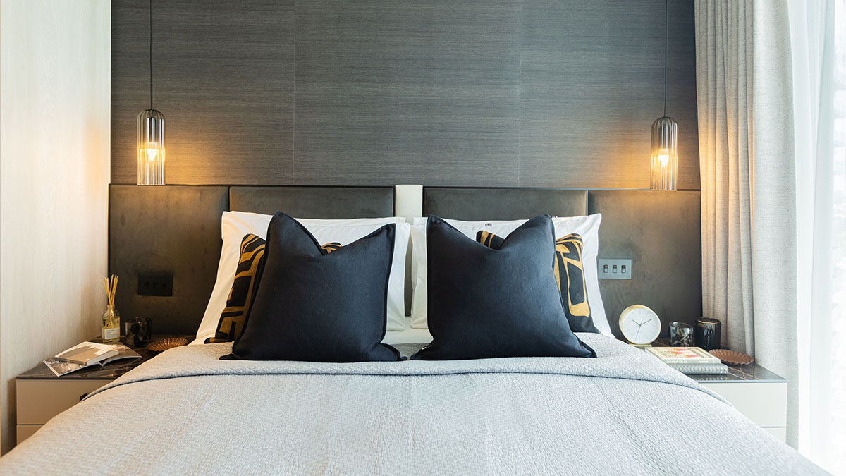 Professionally furnished London bedroom with dark accents, enhancing a flat's rental appeal