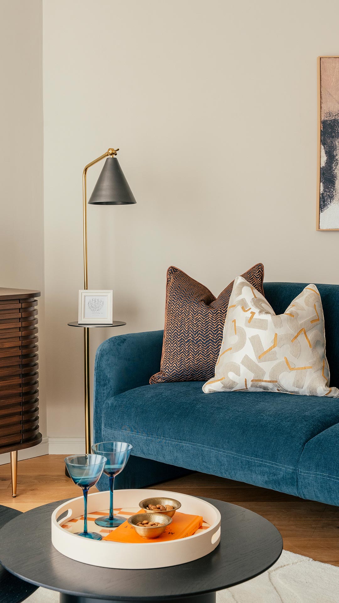Luxurious blue sofa and decorative pillows in a London flat, part of a furnishing package for overseas landlords