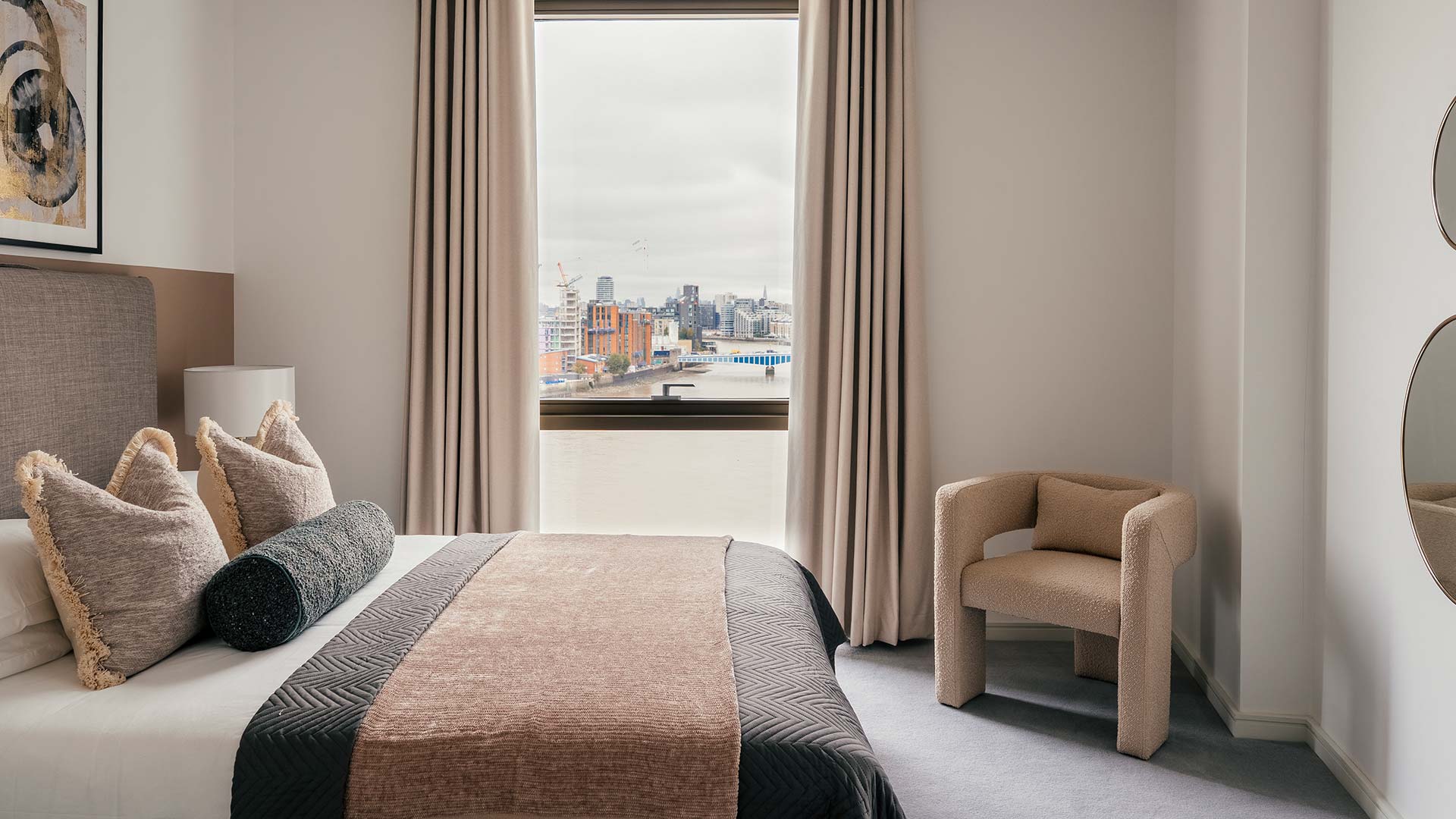 Professionally furnished bedroom with window view in a London flat at Riverside Quarter, enhancing rental appeal