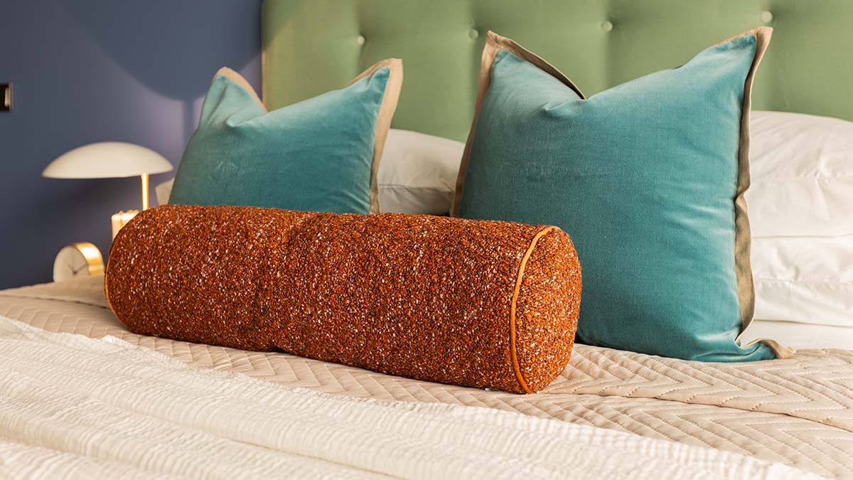 Textured cushions and luxury bedding details, key to a high-yield before and after London flat transformation.