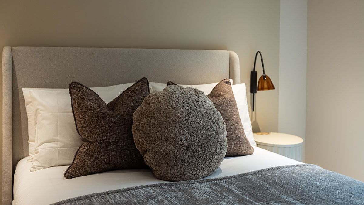 Holiday home bedroom interior design with bespoke sofa in Chelsea Waterfront London