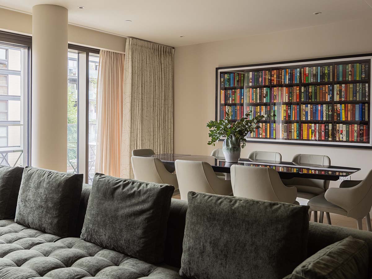 Modern dining set with large wall art in an open-plan London flat transformation.