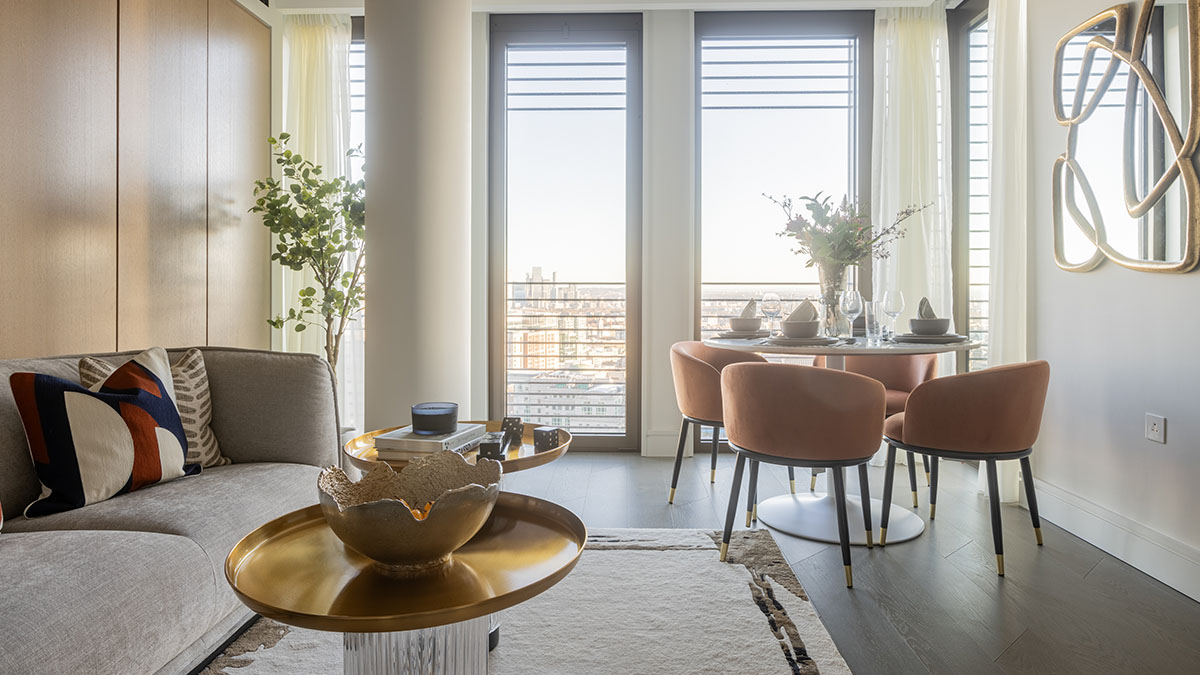 Modern living and dining area with floor-to-ceiling windows and city skyline view at One Bishopsgate Plaza London