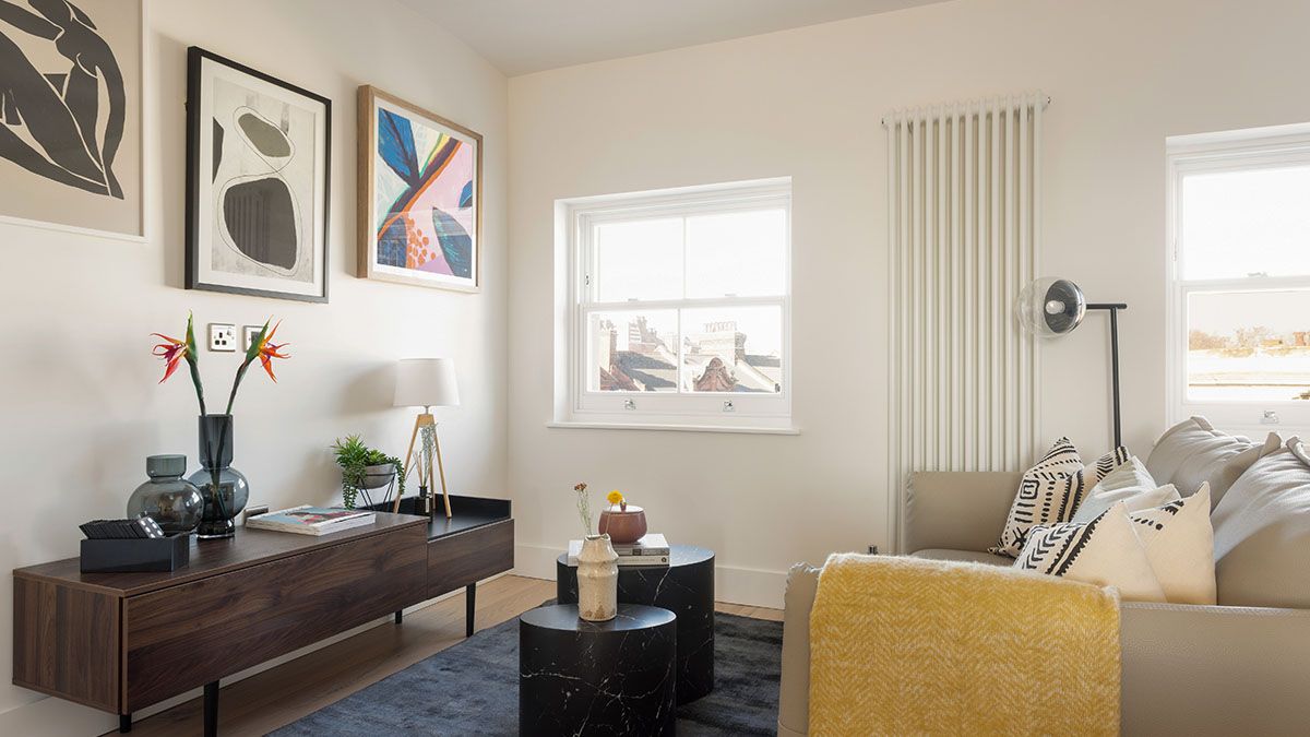 modern build to rent living room with sofa, console table, wall art and decorative accessories in London apartment
