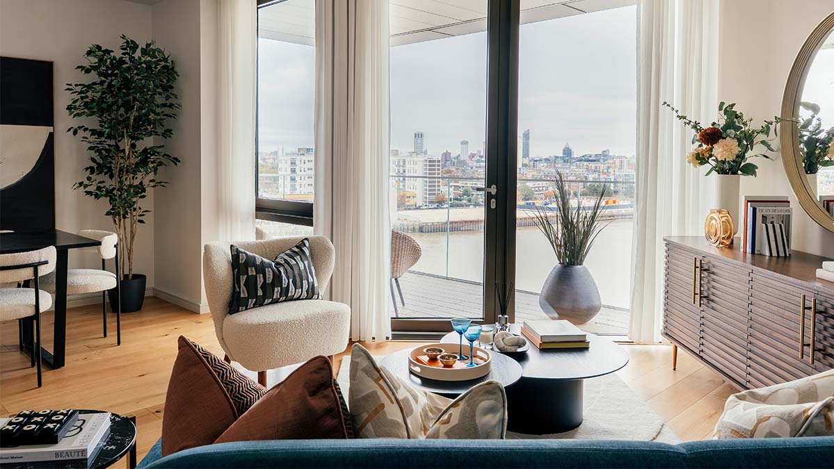 Modern London apartment living room with balcony, river view, neutral furniture and styled interiors