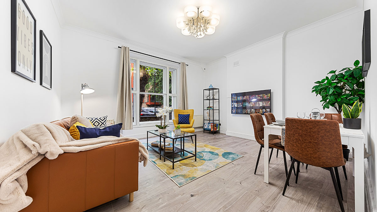 Bright modern living room with dining area, leather seating, patterned rug and contemporary décor