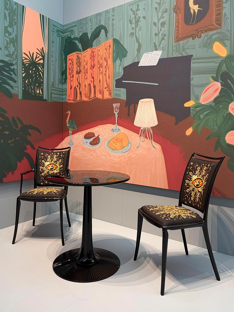 Modern table with chair placed against a decorative printed wall in a stylish interior setting