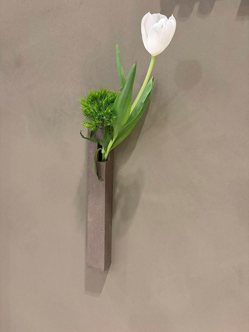 White flower in a decorative pot placed indoors as home decor