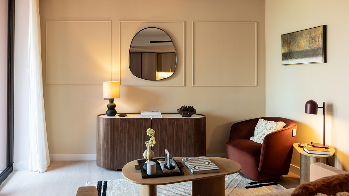 Elegant living room at West End Gate with bespoke furniture, wall panelling, statement lighting and warm neutral décor.