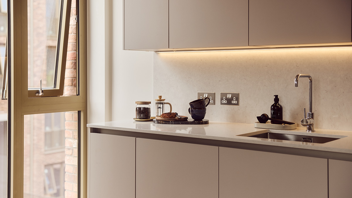 Modern BTR kitchen with handleless cabinetry, quartz worktop, integrated sink, under-cabinet lighting and contemporary styling.