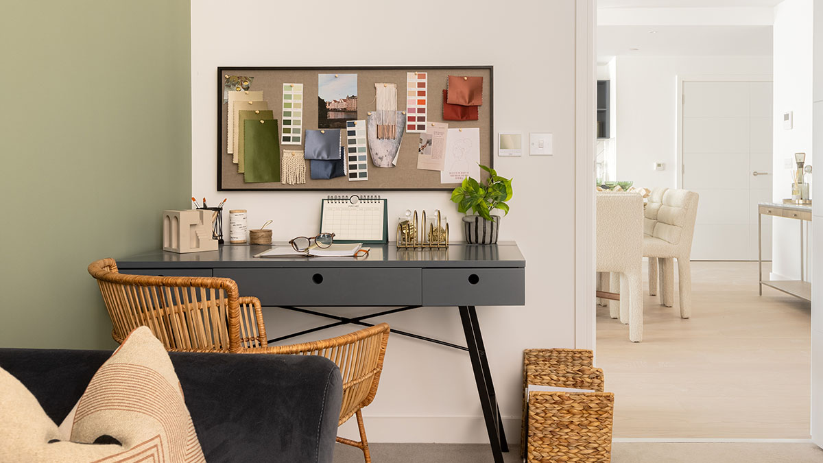 London property home office with a modern desk, rattan chair, storage baskets and a curated interior design scheme.