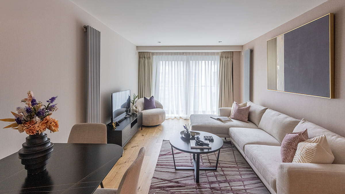 Modern furnished living room with sectional sofa, dining table and contemporary decor