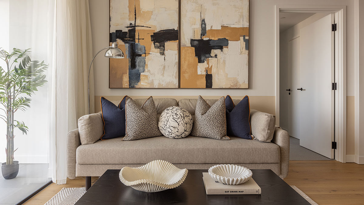 Modern beige sofa with abstract wall art