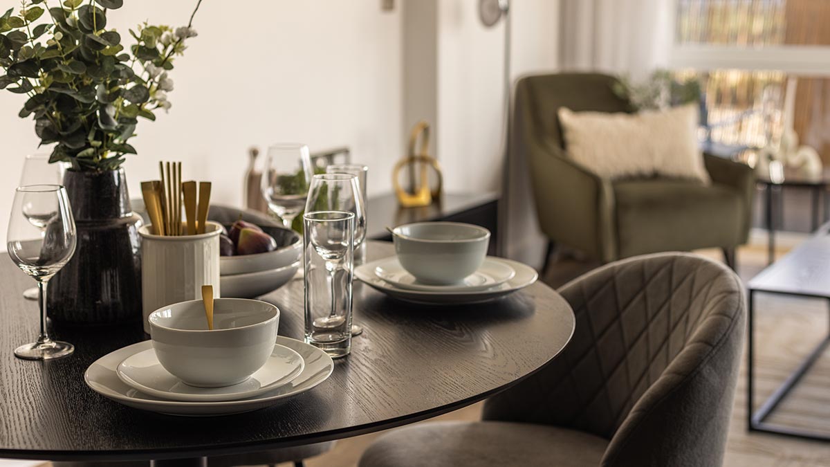 Modern dining table with elegant tableware in a neutral contemporary apartment